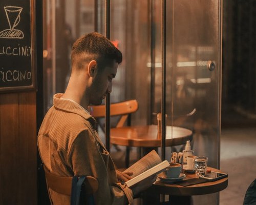 Reading a book in a cafe with natural light